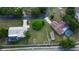 Aerial view of home with screened pool, outbuilding, and long driveway in a serene neighborhood at 107 Garland Cir, Palm Harbor, FL 34683