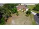 Aerial view of a well maintained home featuring a charming landscape and an expansive driveway at 107 Garland Cir, Palm Harbor, FL 34683