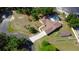 Overhead view of home showcasing fenced yard, long driveway, mature landscaping, and convenient outbuilding at 107 Garland Cir, Palm Harbor, FL 34683