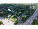 Neighborhood aerial view featuring homes, a pond, mature trees, and a nearby highway for easy access at 107 Garland Cir, Palm Harbor, FL 34683