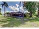 An expansive backyard features a screened pool and a shed at 107 Garland Cir, Palm Harbor, FL 34683