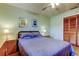 Bedroom with carpet, natural light, floral wall art and closet with louvered doors at 107 Garland Cir, Palm Harbor, FL 34683