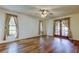 Bright bedroom with hardwood floors and large windows, offering plenty of natural light at 107 Garland Cir, Palm Harbor, FL 34683