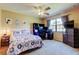 Inviting bedroom boasts a ceiling fan, natural light, a workspace area, and carpeted flooring at 107 Garland Cir, Palm Harbor, FL 34683