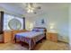 Bedroom with carpet, natural light, a round mirror above the dresser and matching nightstands at 107 Garland Cir, Palm Harbor, FL 34683