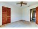 Empty bedroom with carpet, wall trim, closet with louvered doors and ceiling fan at 107 Garland Cir, Palm Harbor, FL 34683