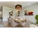 Elegant dining room with modern chandelier and seating for six, perfect for Gathering meals at 107 Garland Cir, Palm Harbor, FL 34683