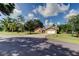 Attractive single-story home with a concrete driveway leading to a two-car garage at 107 Garland Cir, Palm Harbor, FL 34683
