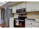 This kitchen features stainless steel appliances, white cabinets and plenty of counter space at 107 Garland Cir, Palm Harbor, FL 34683