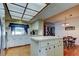 Bright eat-in kitchen with white cabinetry, wood flooring, and a skylight at 107 Garland Cir, Palm Harbor, FL 34683