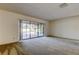Bright living room with carpet, large sliding glass doors, and a view of the pool area at 107 Garland Cir, Palm Harbor, FL 34683