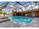 A screened pool is adjacent to the house with plenty of space to relax at 107 Garland Cir, Palm Harbor, FL 34683