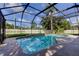 A screened pool with refreshing blue water is perfect for outdoor enjoyment at 107 Garland Cir, Palm Harbor, FL 34683