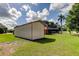 A metal shed is nestled in a well-maintained backyard at 107 Garland Cir, Palm Harbor, FL 34683