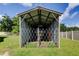 An open metal shed features security bars at 107 Garland Cir, Palm Harbor, FL 34683