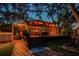Backyard with a spacious deck, lush lawn, and brick pathway at 11209 Spring St, Largo, FL 33774