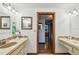 Bathroom with double sinks, wooden doorframes, and a mirror on the wall at 11209 Spring St, Largo, FL 33774