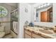 Cozy bathroom with mosaic tile accents on the vanity and shower, complemented by natural light from a porthole window at 11209 Spring St, Largo, FL 33774