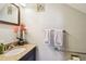 Comfortable bathroom with granite-topped vanity, decorative mirror, and accessibility features at 11209 Spring St, Largo, FL 33774