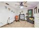 Bright bedroom featuring neutral carpet, ceiling fan, closet, and rocking chairs at 11209 Spring St, Largo, FL 33774