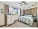 Cozy bedroom with a large window, curtains, and a queen-sized bed with decorative pillows at 11209 Spring St, Largo, FL 33774