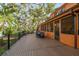 Expansive deck overlooking a lush green backyard, screened in porch and various plants at 11209 Spring St, Largo, FL 33774