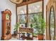 Sunlit entryway with a grandfather clock, stylish accent table, and a decorative stained-glass light fixture at 11209 Spring St, Largo, FL 33774