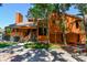 Two-story orange home featuring a covered porch, wood siding, and brick accents along the sidewalk at 11209 Spring St, Largo, FL 33774