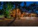 Stunning wood home featuring lush landscaping and a porte cochere with brick-paved driveway at 11209 Spring St, Largo, FL 33774