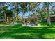 Backyard fire pit with seating, and a lush lot featuring an outdoor bar at 11209 Spring St, Largo, FL 33774