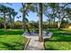 Cozy backyard fire pit with seating surrounded by a lush lawn at 11209 Spring St, Largo, FL 33774