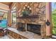 Close-up of the stone fireplace, featuring a stone hearth and wood mantle at 11209 Spring St, Largo, FL 33774
