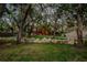 Two story home with a beautiful front yard, mature trees, and rock borders at 11209 Spring St, Largo, FL 33774