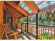 Well-lit front porch with clear roof panels, rocking chair, and wood railing detail at 11209 Spring St, Largo, FL 33774