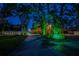 Expansive front yard and beautiful exterior with mature trees and green landscape lighting at 11209 Spring St, Largo, FL 33774