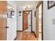 Hallway with wooden doorframes and hardwood floors leading to a bathroom and other rooms at 11209 Spring St, Largo, FL 33774