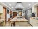 Bright kitchen with stainless steel appliances and an island cooktop opening to other rooms at 11209 Spring St, Largo, FL 33774