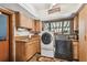 This laundry room includes a washer, dryer, sink, and plenty of storage space at 11209 Spring St, Largo, FL 33774