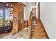 Open-concept living room featuring a unique wooden accent wall, staircase to the second floor, and views of the main living space at 11209 Spring St, Largo, FL 33774