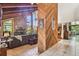 Open-concept living room with high ceilings, a stone fireplace, and tile flooring at 11209 Spring St, Largo, FL 33774