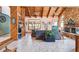 Open living room with stone fireplace, wood ceilings, and tile floors at 11209 Spring St, Largo, FL 33774