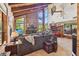 Spacious living room featuring a stone fireplace, high ceilings, and large windows at 11209 Spring St, Largo, FL 33774