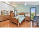 Bright and airy bedroom with wooden furniture, ceiling fan, and plenty of natural light at 11209 Spring St, Largo, FL 33774