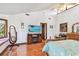 A bright bedroom featuring vaulted ceilings, wood floors, and a large media center at 11209 Spring St, Largo, FL 33774