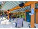 Inviting outdoor bar featuring ceiling fan, string lights, speakers, and a view of the spacious backyard at 11209 Spring St, Largo, FL 33774