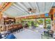 Inviting outdoor bar with a wooden bar top and view of the backyard sitting area at 11209 Spring St, Largo, FL 33774
