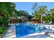 Beautiful pool area with an outdoor kitchen, a hot tub gazebo, and several trees for a tranquil setting at 11209 Spring St, Largo, FL 33774
