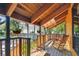 Inviting porch with rocking chair, hanging plants, and natural wood accents at 11209 Spring St, Largo, FL 33774