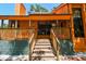 Charming front porch with wooden railings and steps, complete with hanging floral baskets at 11209 Spring St, Largo, FL 33774