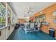 Enclosed porch with a wooden ceiling, ceiling fans, and views of the lush landscaping at 11209 Spring St, Largo, FL 33774